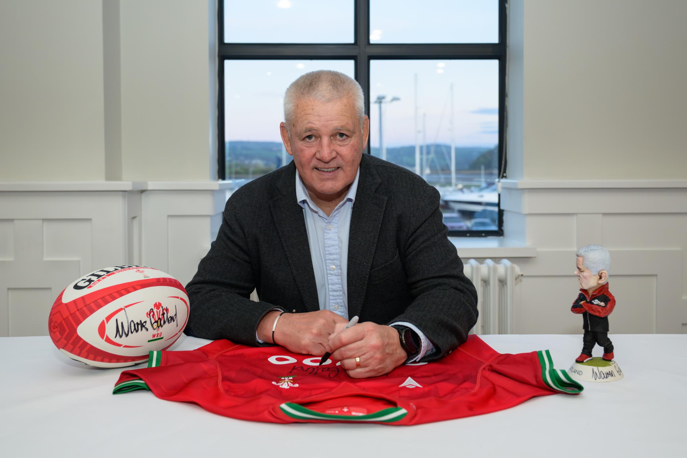 Warren Gatland signs auction items at the Deganwy Quay Hotel