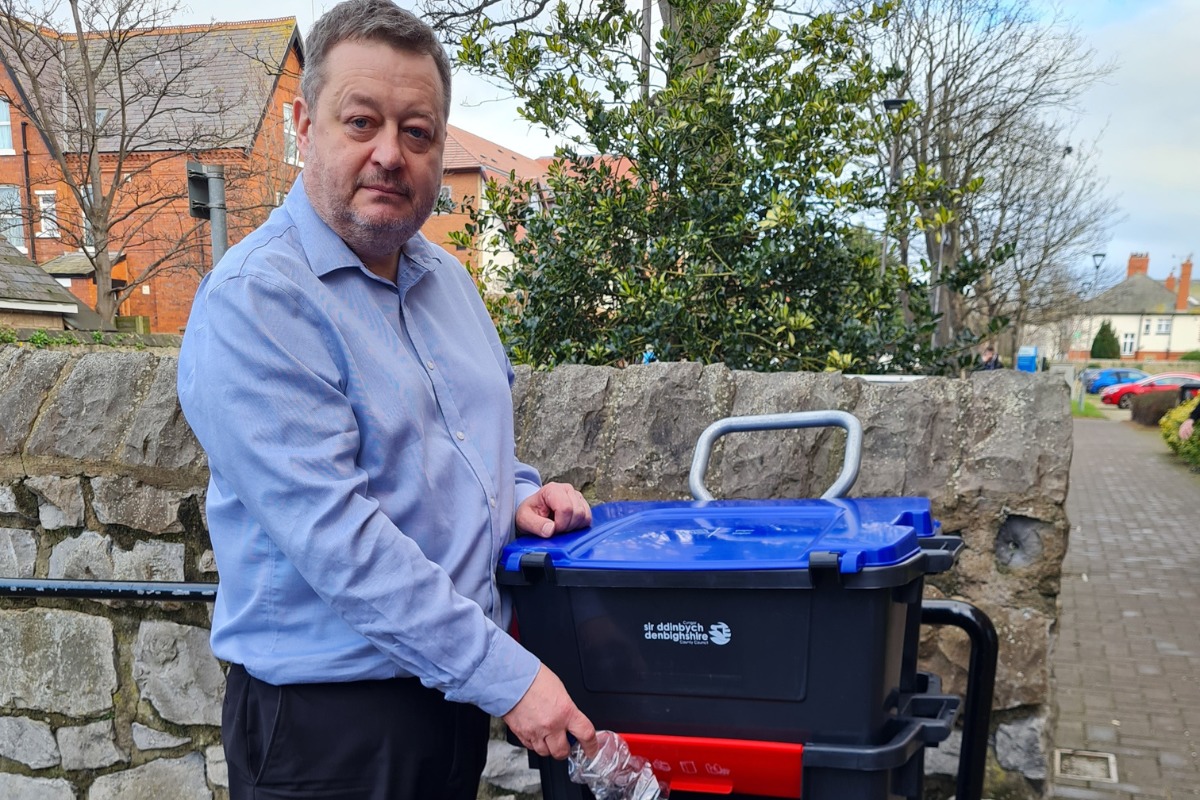 Denbighshire leader Cllr Jason McLellan with one of the councils new recycling Trolibocs on wheels - to replace their blue bin..