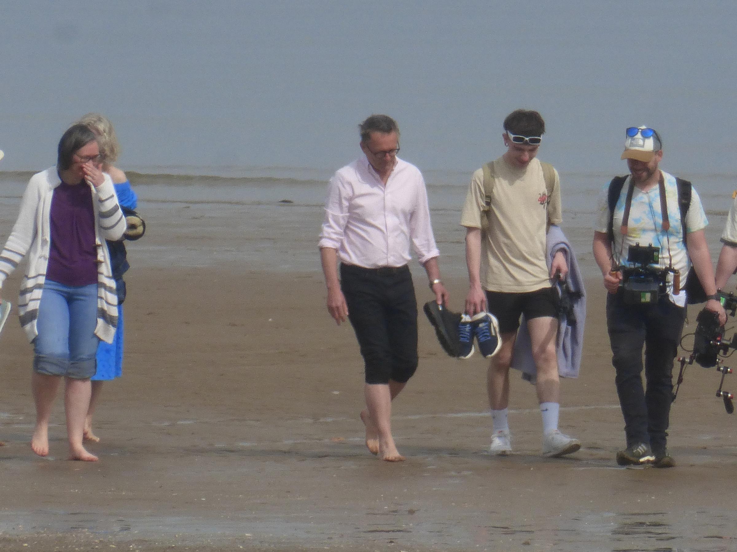 Michael Mosley seen alongside wife Clare and others, including a camera crew, at Colwyn Bay, north Wales, on May 10 — just weeks before his disappearance in Symi, Greece. Release date June 10 2024. Pictures have surfaced of TV presenter Michael